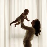 A loving mother holding her baby, symbolizing the emotional bond between mother and daughter – Aarohi Blog