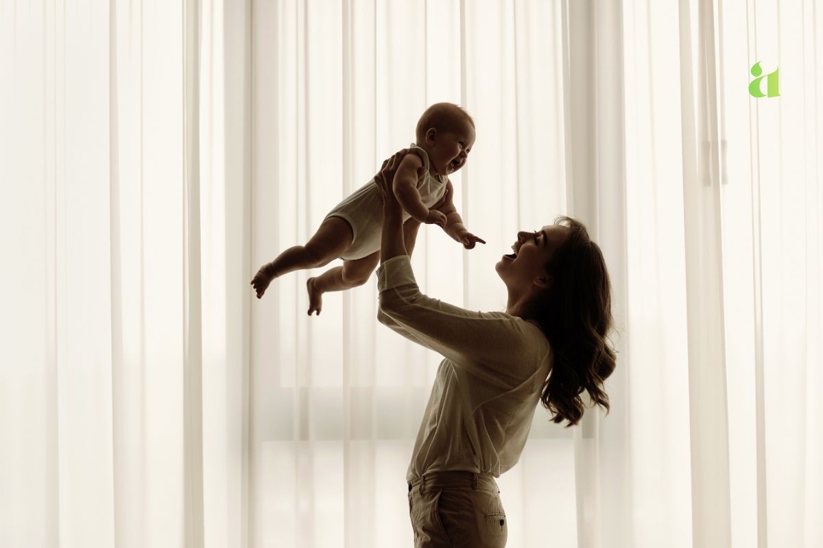 A loving mother holding her baby, symbolizing the emotional bond between mother and daughter – Aarohi Blog