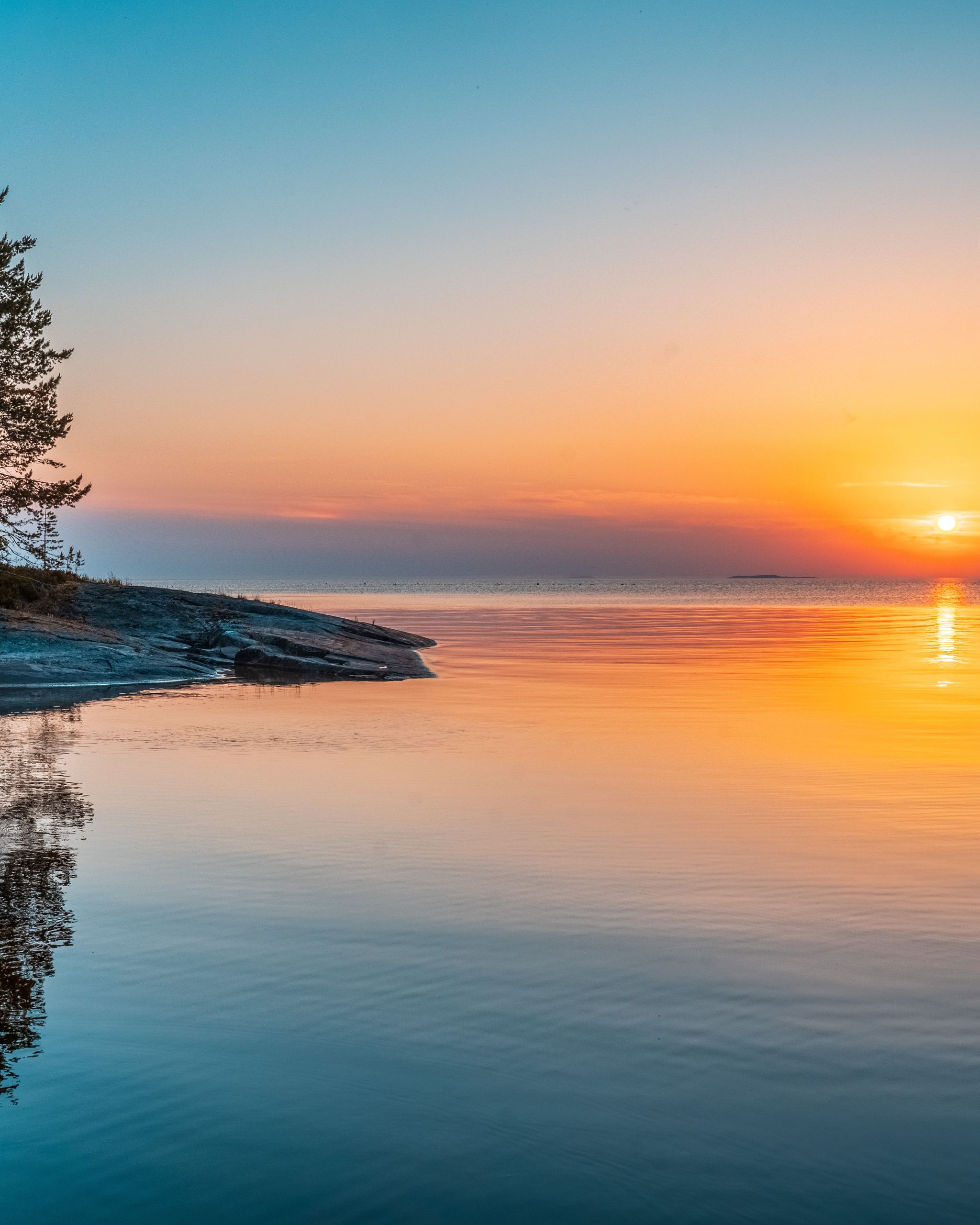 Still water reflecting a quiet sunrise, expressing pause, stillness, and gentle transition