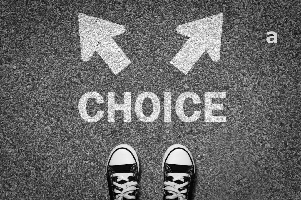 the difference between a wish and a decision person standing at a crossroads reflecting on life choices