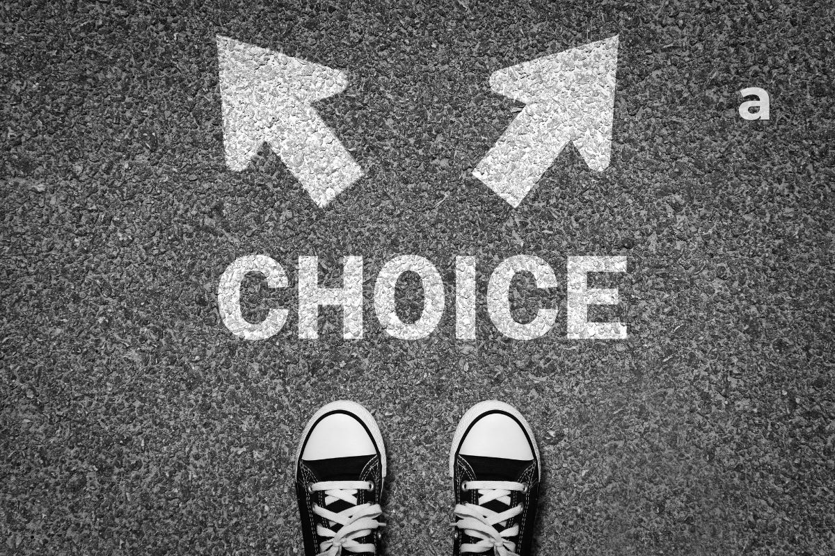the difference between a wish and a decision person standing at a crossroads reflecting on life choices