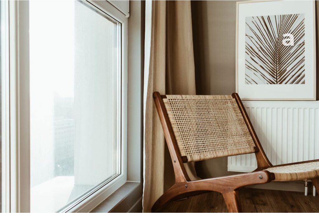 A familiar empty chair beside a window representing emotional attachment, comfort, and familiarity after a breakup.