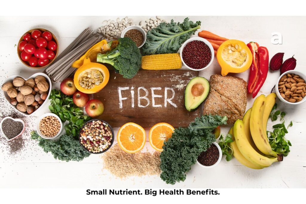 A colorful assortment of high-fiber foods including oats, lentils, beans, apples, pears, broccoli, chia seeds, whole grains, nuts, and vegetables representing a healthy, fiber-rich diet.