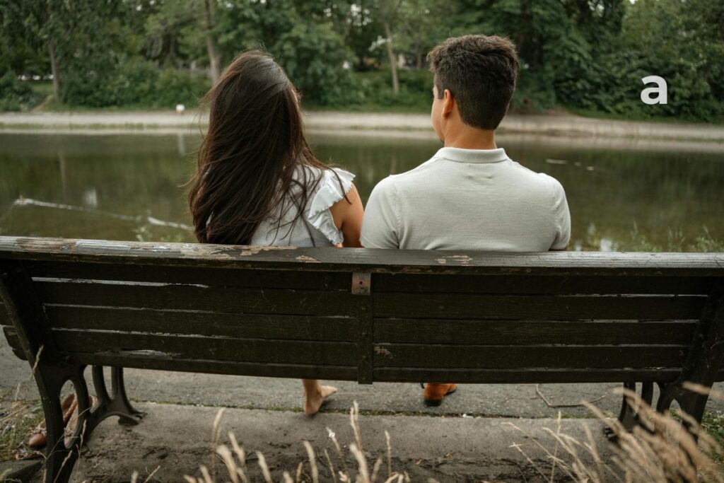 Two childhood friends sitting on separate benches, reflecting how personal growth can lead people in different directions over time.