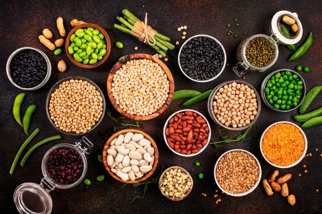 Top high-fiber foods including beans, lentils, oats, fruits, vegetables, nuts, and seeds.