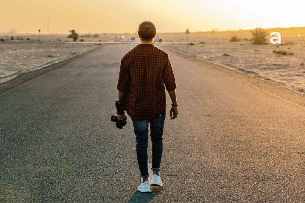 A person walking toward a sunrise, symbolizing personal growth, self-discovery, and moving forward after outgrowing relationships.