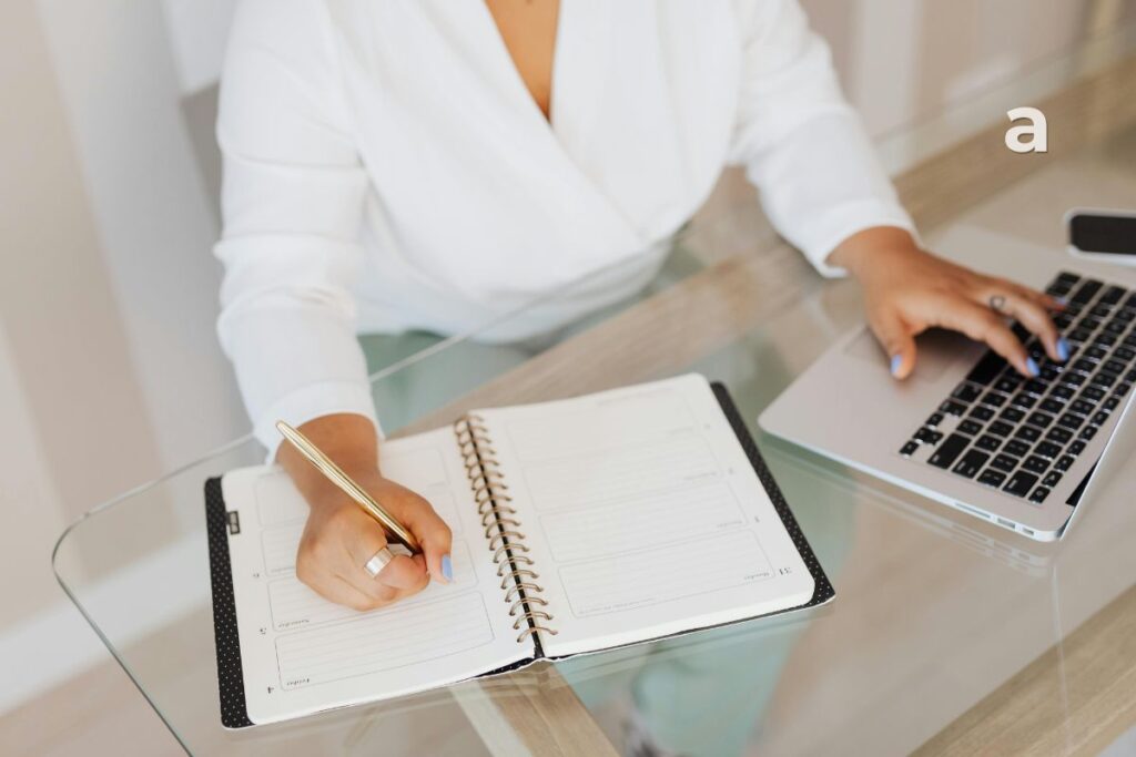 Person surrounded by work and digital distractions while reflecting on time