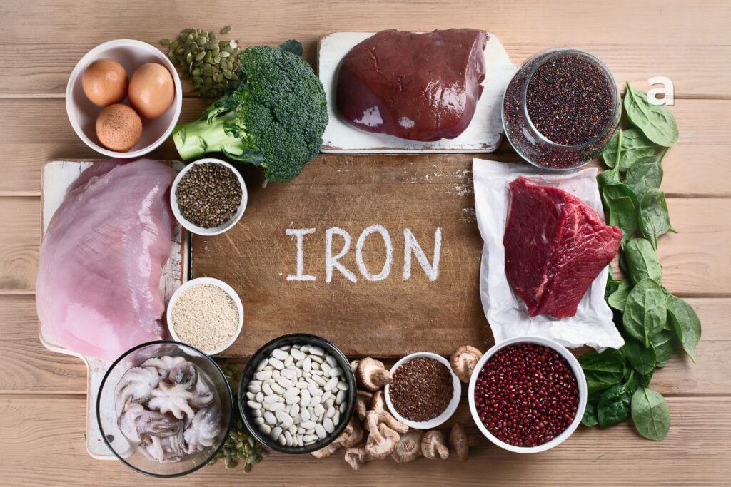 Iron benefits with iron-rich foods including lean beef, spinach, lentils, eggs, beans, pumpkin seeds, and fortified cereals for healthy blood and energy.