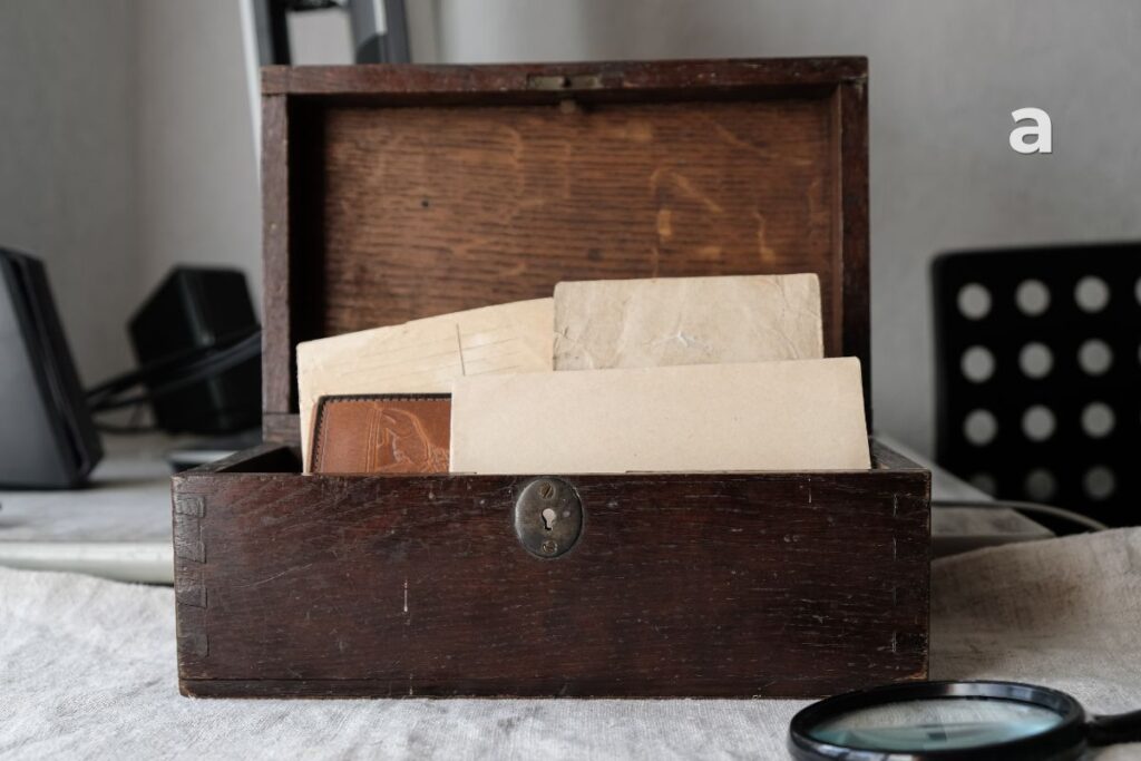 An old metal box filled with handwritten notes and an old photograph