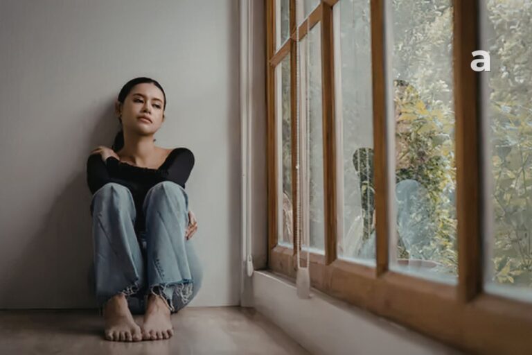 Woman reflecting on the invisible cost of always being the strong one