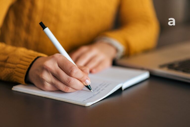 A beginner learning how to start journaling with a notebook and pen.