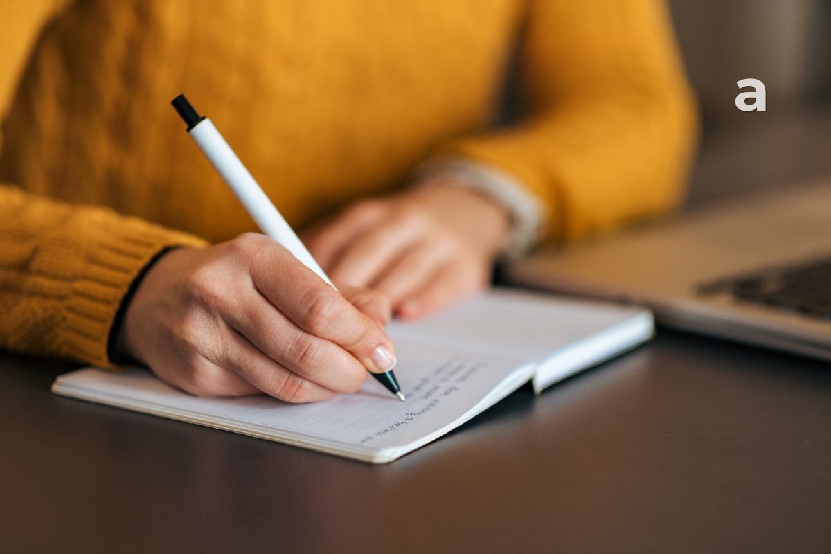 A beginner learning how to start journaling with a notebook and pen.